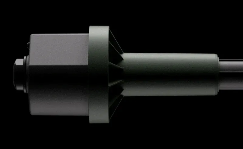 Close-up of a sleek black and green microphone design on a dark background.