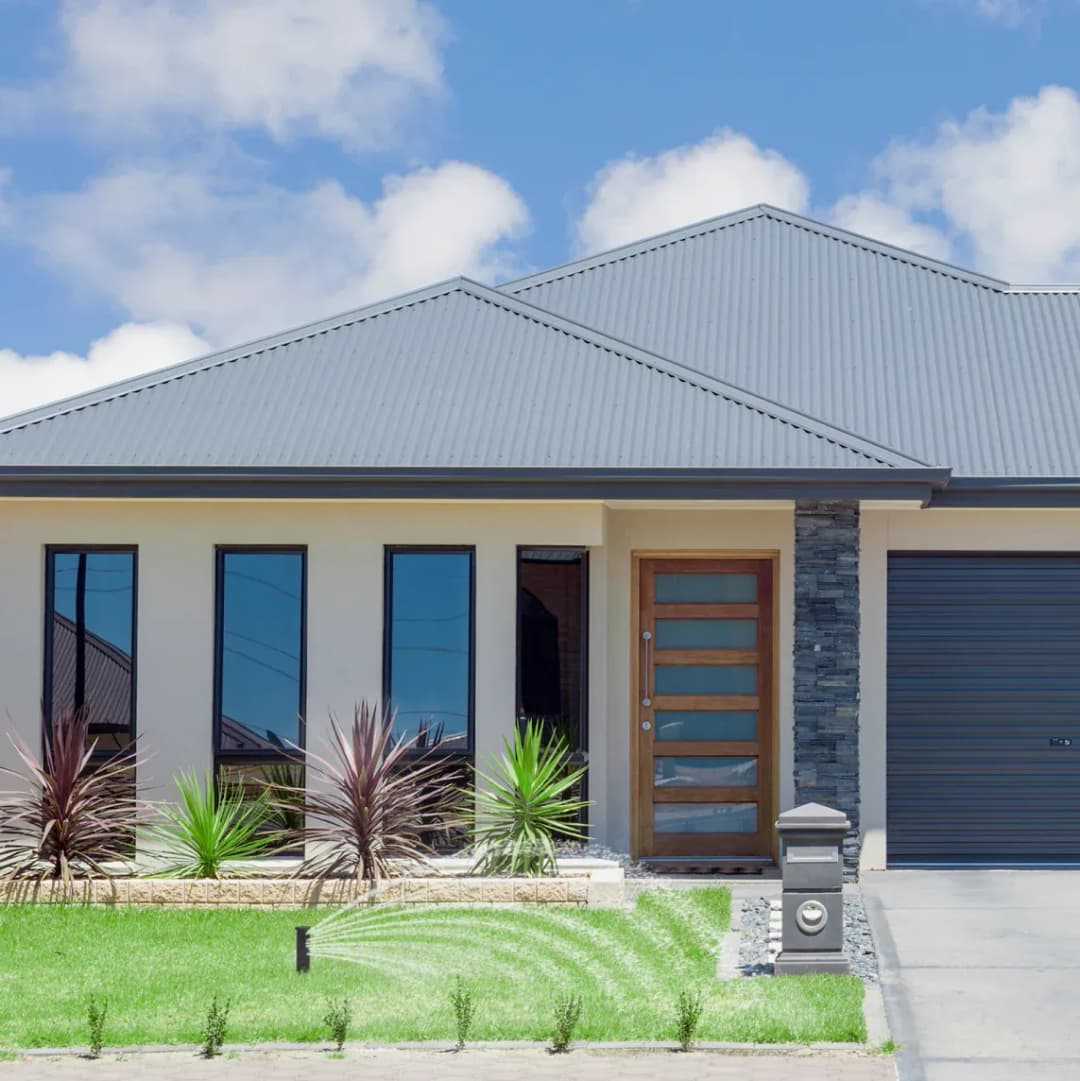 Modern home exterior with a sleek design, large windows, and a stylish front door.