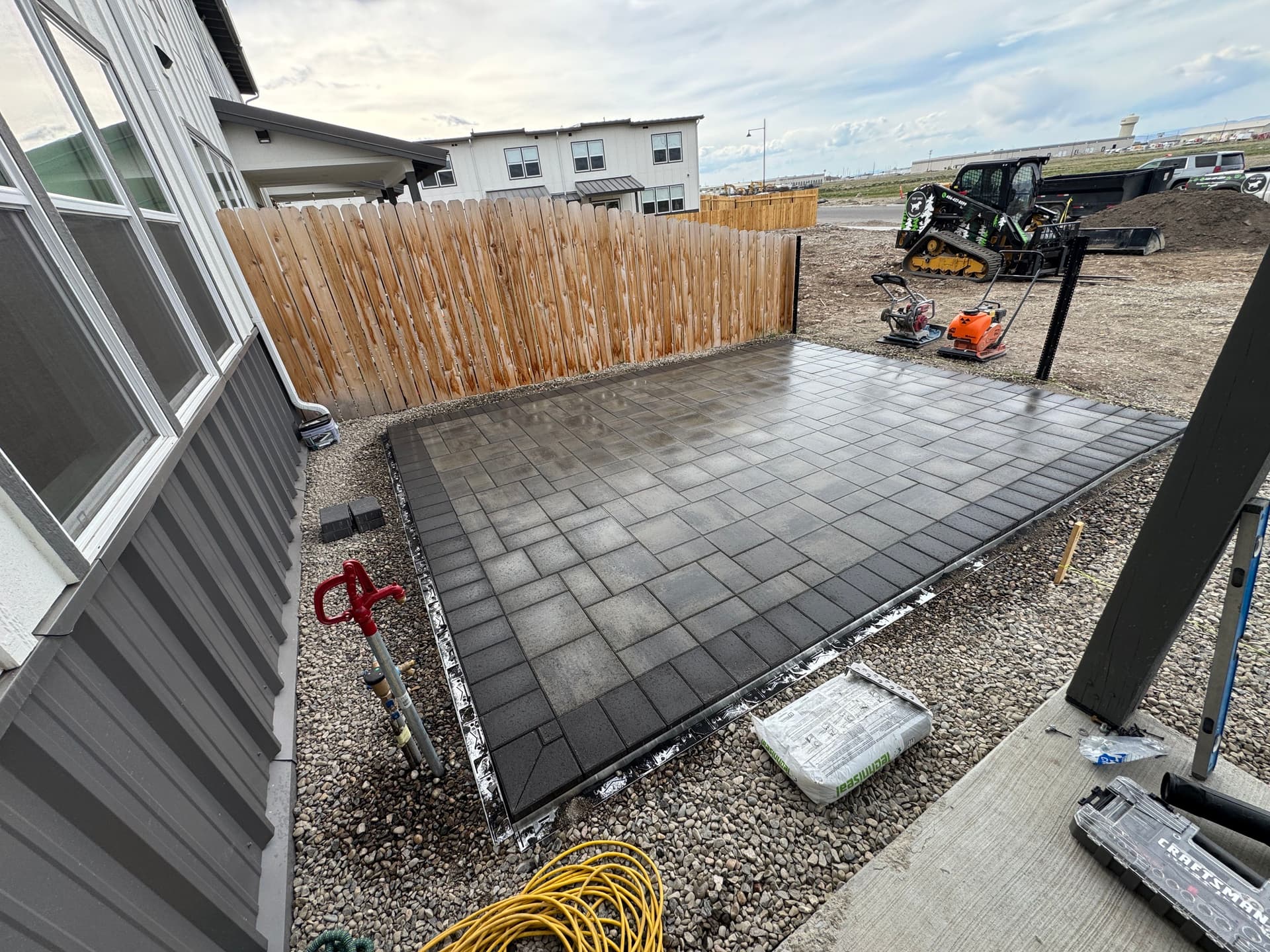 From Gravel Lot to Clean Backyard Paver Patio image